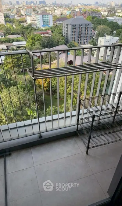 Stunning balcony view overlooking lush greenery and cityscape.