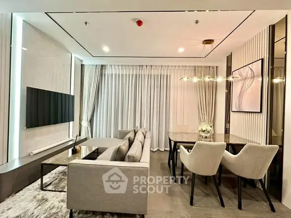 Modern living room with elegant decor and dining area, featuring sleek furniture and ambient lighting.