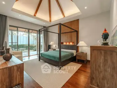 Luxurious bedroom with elegant wooden decor and garden view, featuring a stylish four-poster bed and ample natural light.