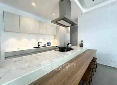 Modern kitchen with sleek design, marble countertops, and integrated appliances for luxurious living.