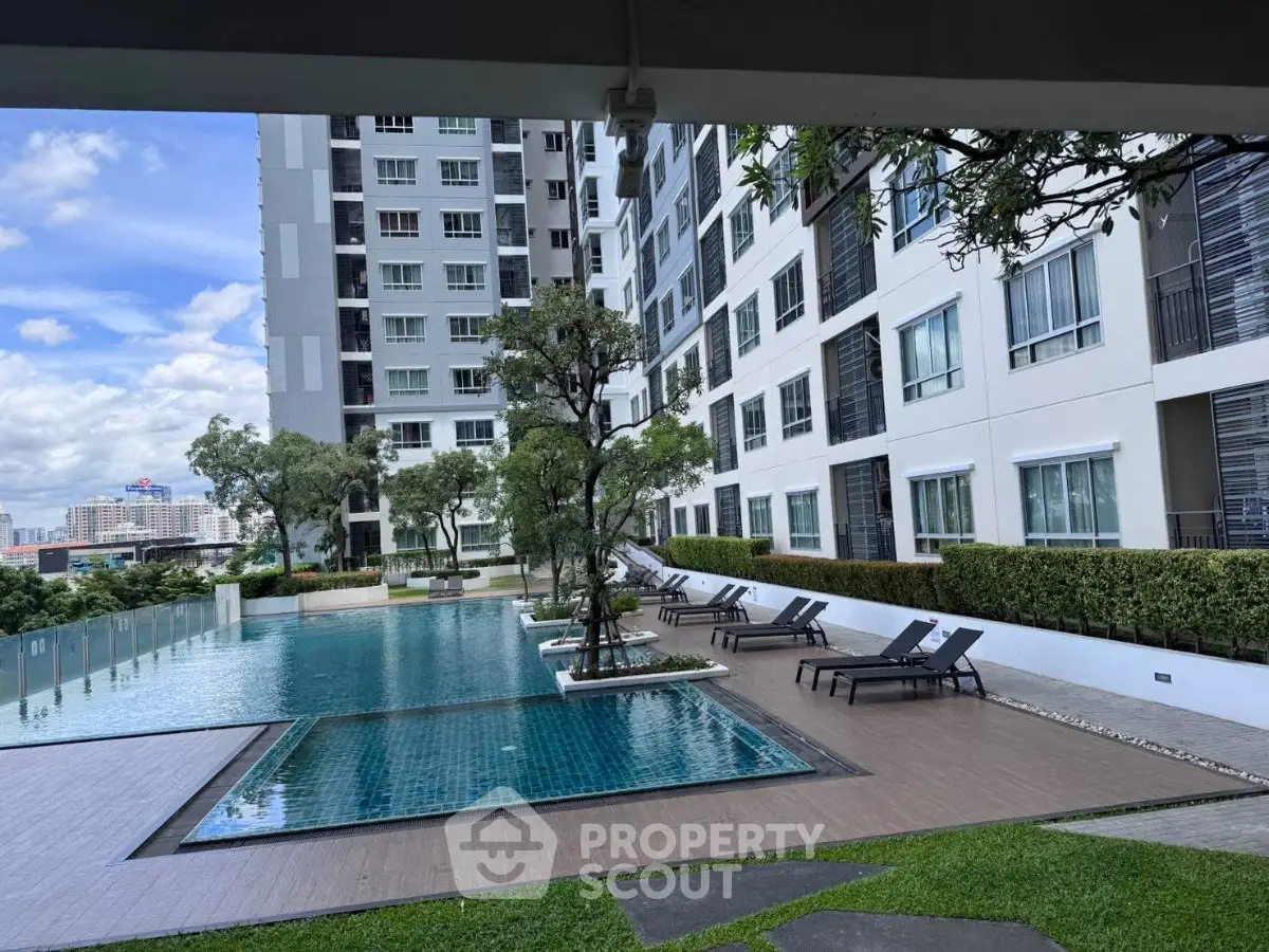 Luxurious condominium with a stunning poolside view and modern architecture, perfect for urban living.
