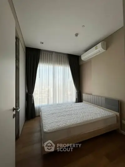 Modern bedroom with large window and air conditioning unit