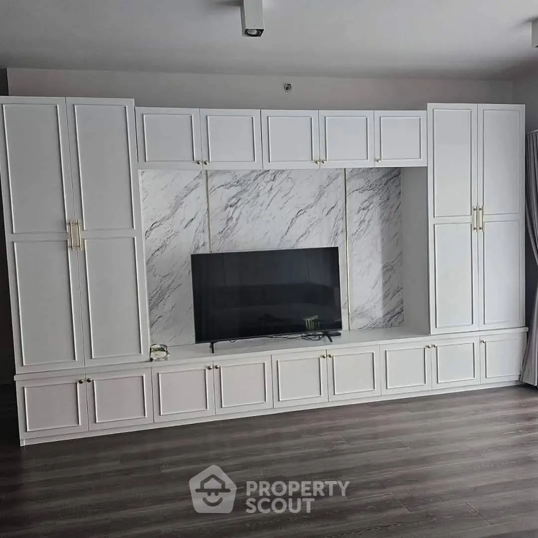 Elegant living room with custom built-in cabinetry and modern TV setup.