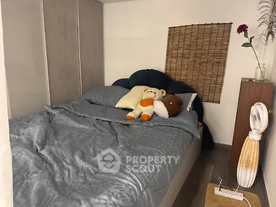 Cozy bedroom with plush bedding and decorative accents for a warm ambiance.