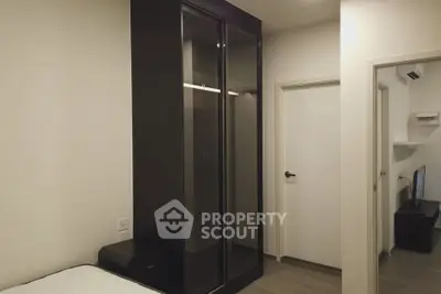Modern bedroom with sleek black wardrobe and minimalist decor