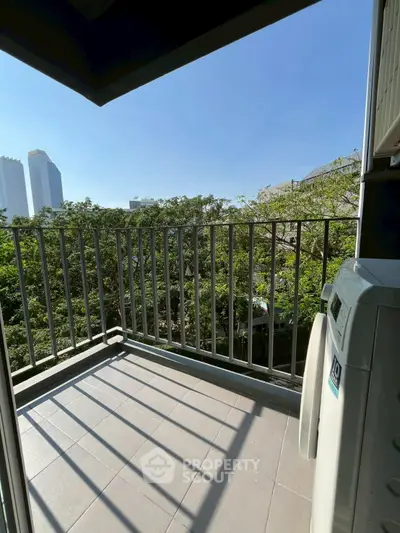 Charming balcony with city view and lush greenery, perfect for relaxation.