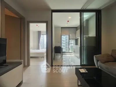 Modern apartment interior with open layout, featuring a sleek kitchen and bright living area.
