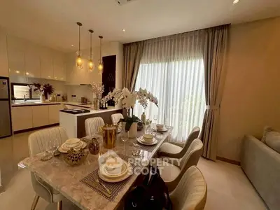 Luxurious open-layout kitchen and dining area with elegant decor and modern lighting.