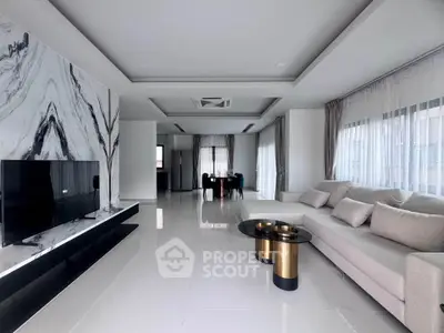 Luxurious modern living room with marble accent wall and sleek furniture