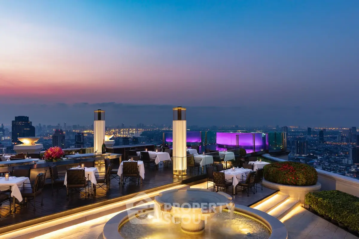 Stunning rooftop dining area with panoramic city views at sunset, perfect for luxury living.
