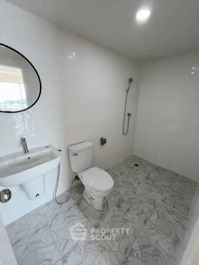 Modern bathroom with sleek white tiles and minimalist fixtures