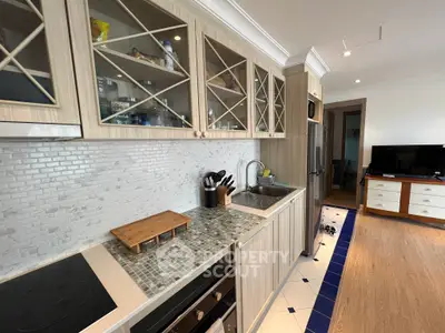 Charming kitchen with modern appliances and stylish cabinetry in cozy apartment.