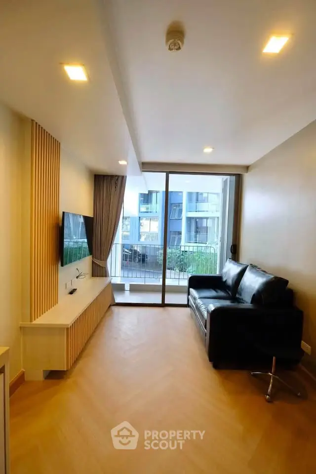 Modern living room with sleek design and balcony view in urban apartment