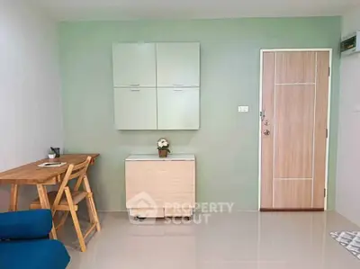 Modern minimalist interior with light wood furniture and green accent wall