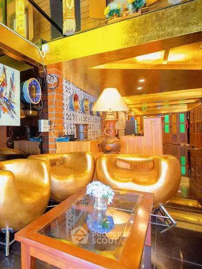 Luxurious living room with golden decor and modern furniture