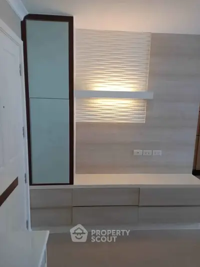 Modern interior with sleek built-in storage and ambient lighting, perfect for contemporary living spaces.