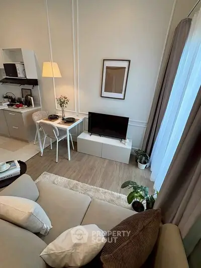 Cozy living room with modern decor and natural light, perfect for relaxation.