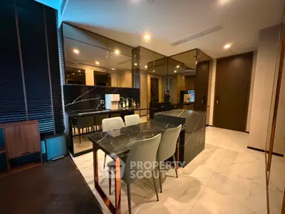 Luxurious modern kitchen with sleek marble countertops and elegant dining area in upscale apartment.