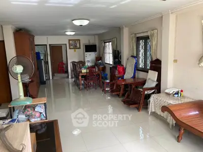 Spacious living room with elegant wooden furniture and large windows for natural light.