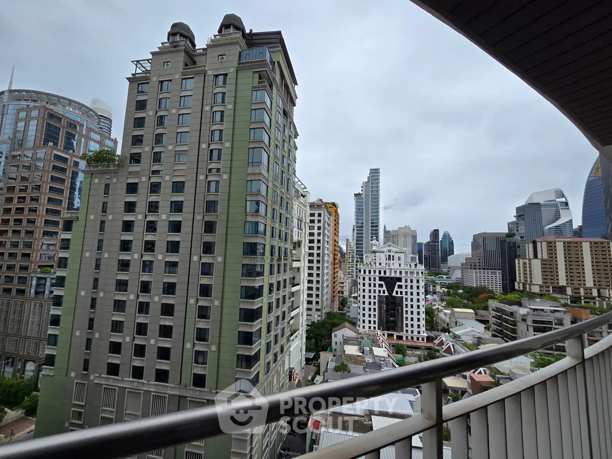 Stunning cityscape view from a high-rise balcony showcasing modern skyscrapers and urban architecture.