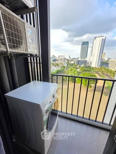 Modern balcony with washing machine and city view, perfect for urban living.