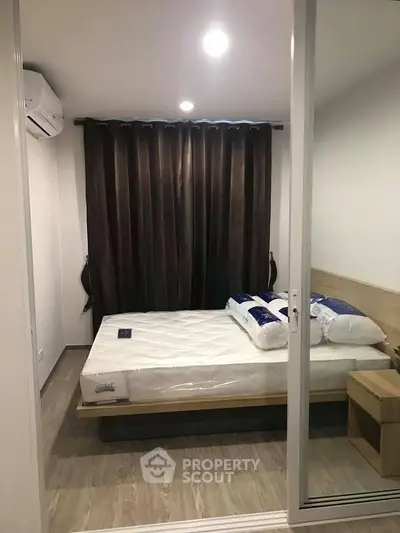 Cozy bedroom with modern furnishings and ambient lighting, perfect for restful nights.