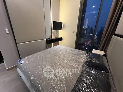 Modern bedroom with city view and sleek furnishings