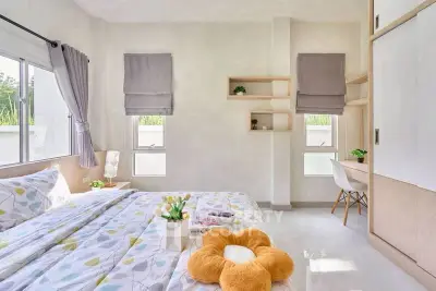 Bright and airy bedroom with modern decor and large windows for natural light.