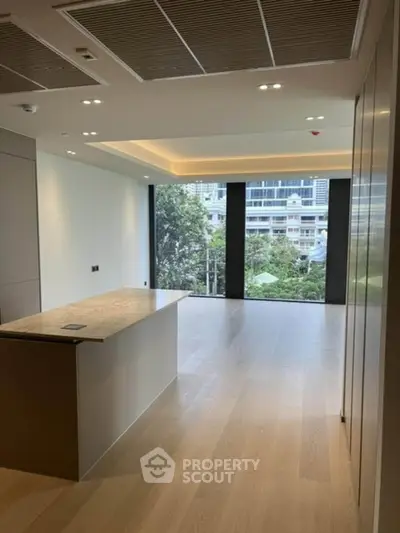 Luxurious open-plan living space with modern kitchen island and city view.