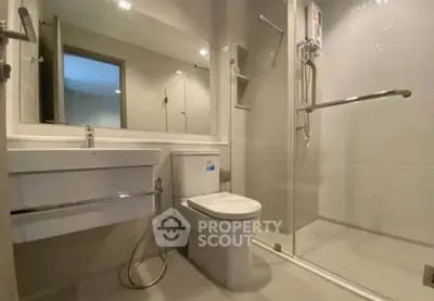 Modern bathroom with sleek fixtures and glass shower enclosure