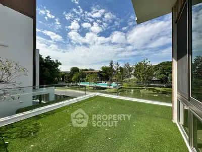 Stunning balcony view with lush greenery and serene water feature