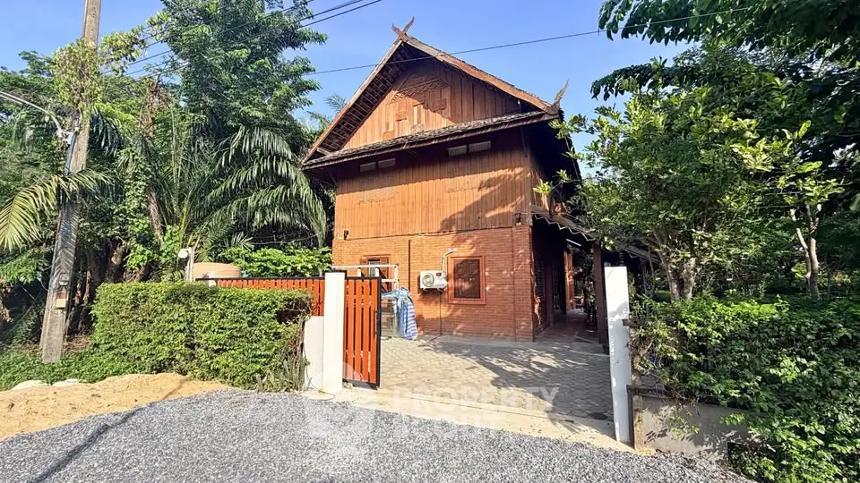 Charming rustic wooden house with lush greenery and gated entrance