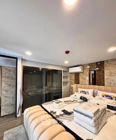 Luxurious bedroom with modern design, featuring a plush bed and elegant marble accents.