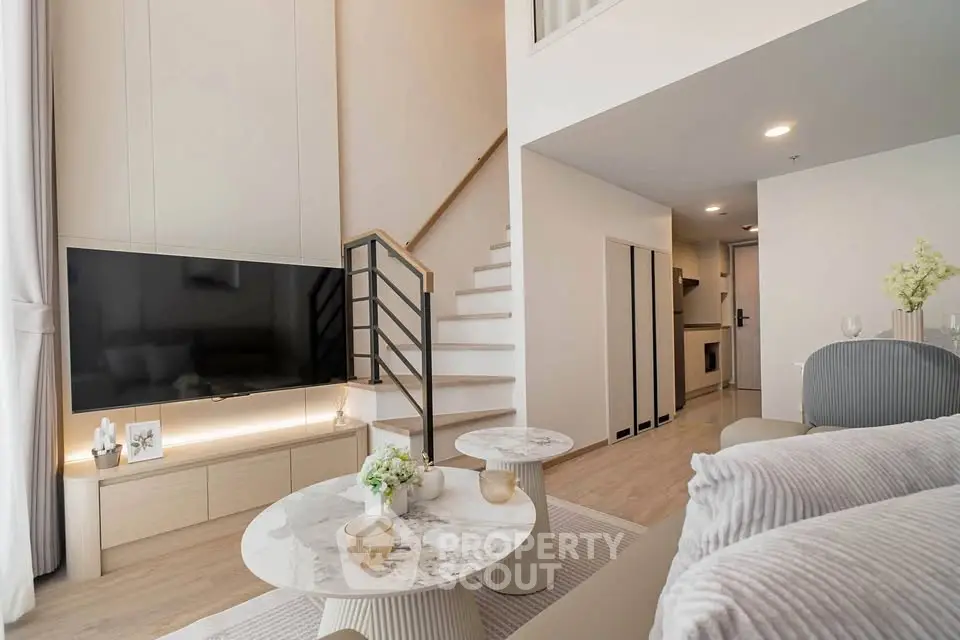 Modern duplex living room with stylish decor and open staircase