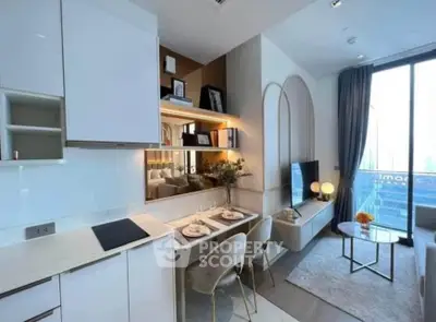 Modern open-plan living room with stylish kitchen and dining area, featuring large windows and elegant decor.