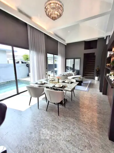 Luxurious open-plan living room with pool view and elegant dining area