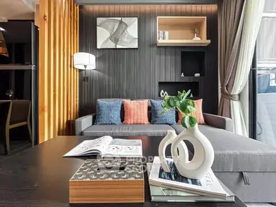 Modern living room with stylish decor, cozy sofa, and elegant coffee table setup.