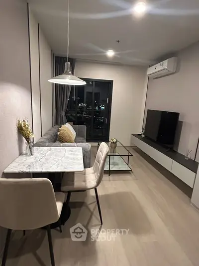 Modern living room with stylish furniture and city view from balcony.