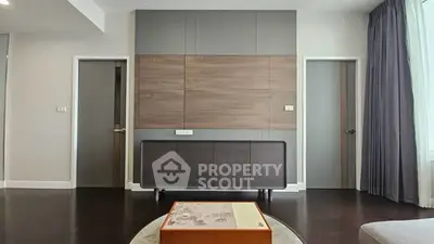 Modern living room with stylish wood paneling and dark flooring