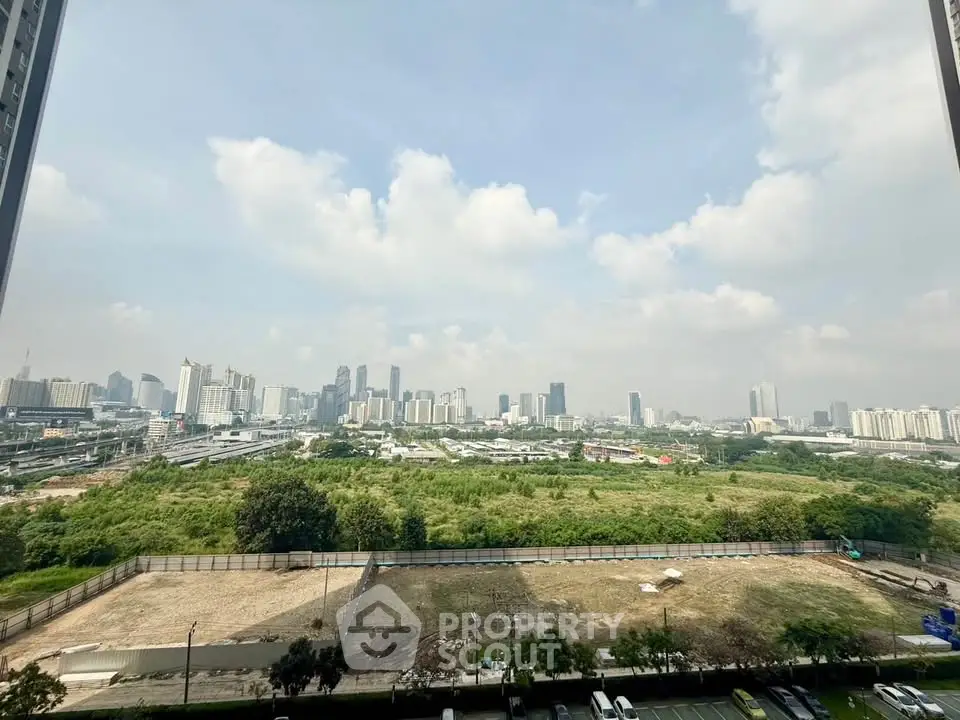 Stunning cityscape view from high-rise apartment balcony, showcasing urban skyline and lush greenery.