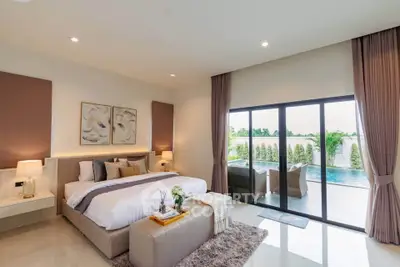 Luxurious bedroom with pool view and elegant decor, perfect for relaxation and comfort.
