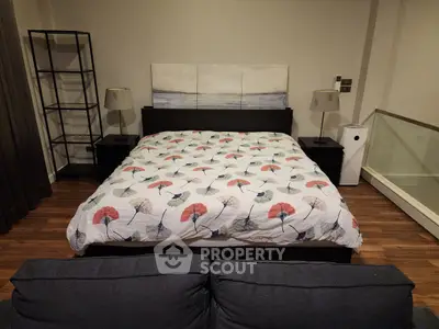 Cozy bedroom with stylish decor and modern furniture, featuring a comfortable bed and elegant lighting.