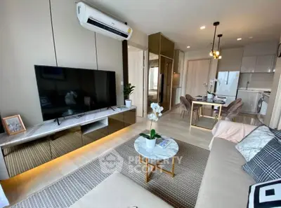 Modern living room with sleek furniture and open kitchen layout