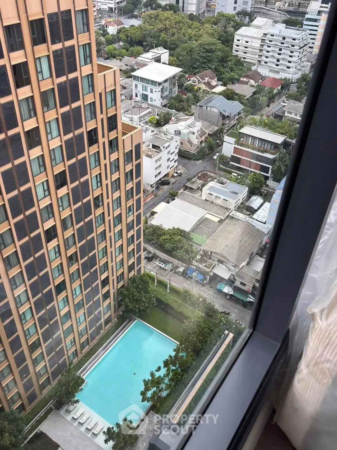 Stunning high-rise view with pool and cityscape, perfect for urban living.