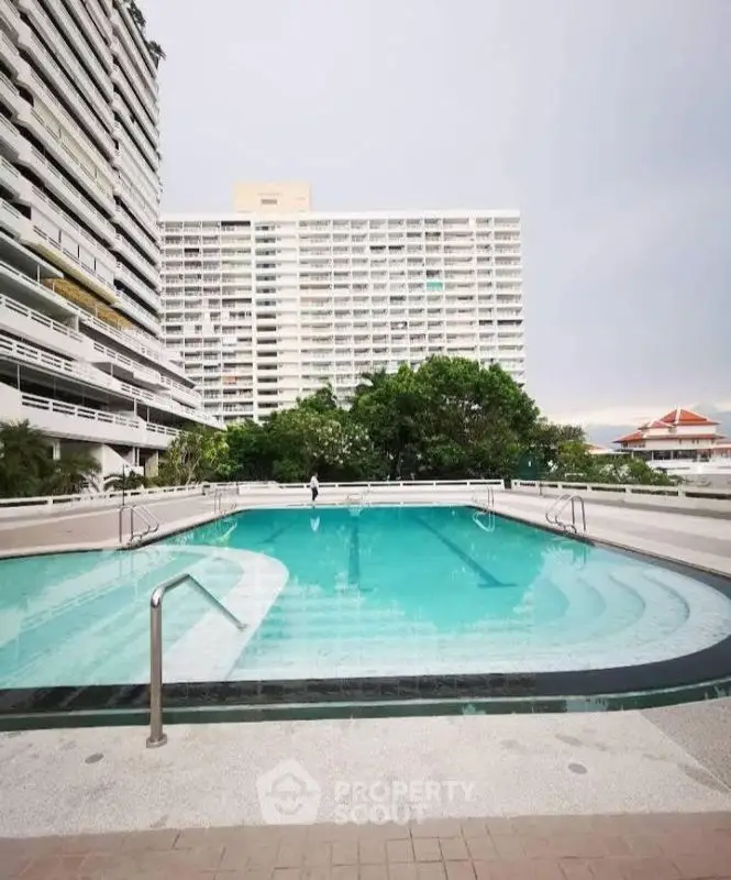 Luxurious residential pool with modern high-rise buildings in the background