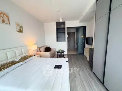 Modern bedroom with stylish decor and ample storage in a contemporary apartment.