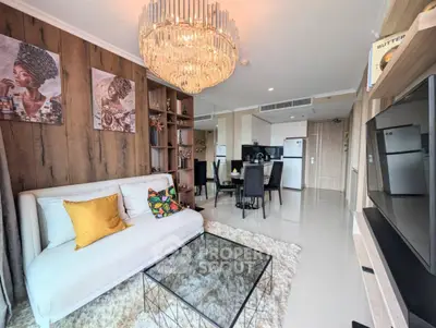 Luxurious living room with elegant chandelier and modern open kitchen layout