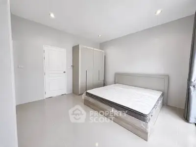 Spacious modern bedroom with sleek design and ample natural light