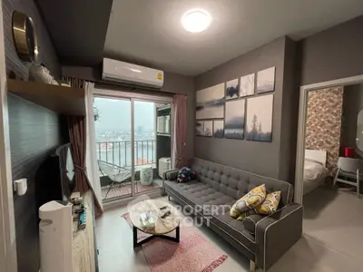 Modern living room with balcony view, stylish decor, and cozy ambiance
