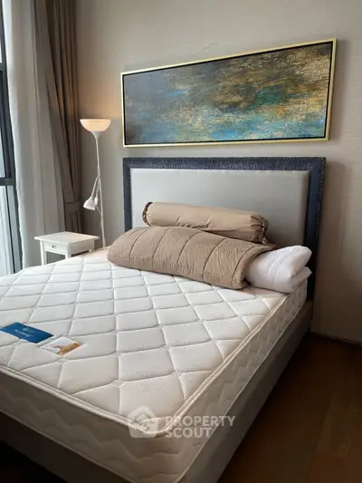 Modern bedroom with stylish decor and comfortable bed in a well-lit space.